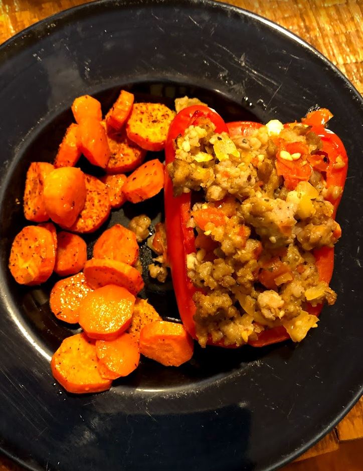 Stuffed bell pepper with roasted carrots.