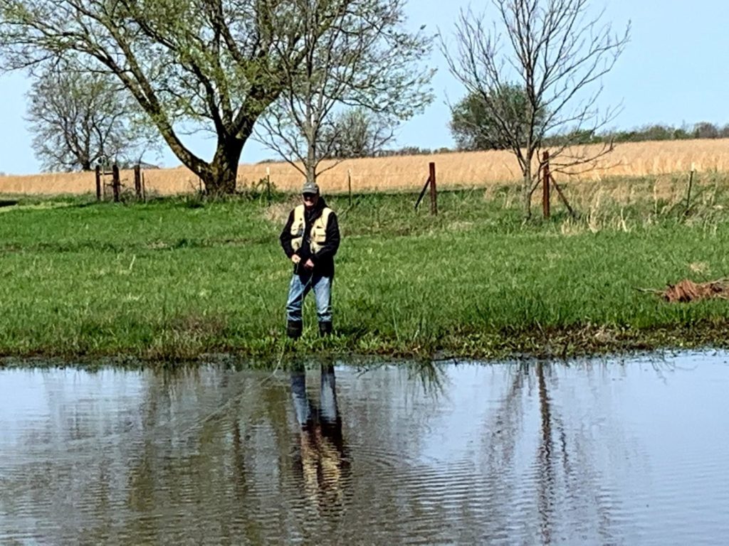 Picture of Scott fly fishing in the pond.